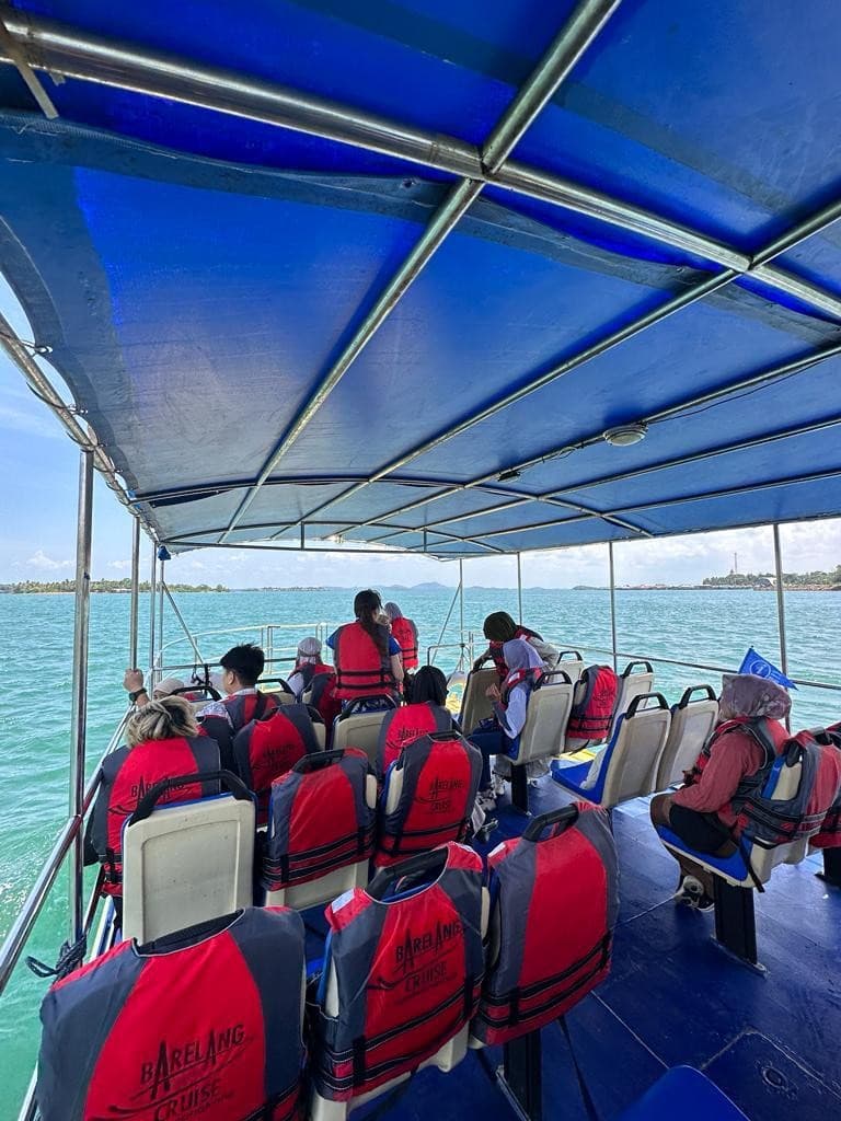 The shaded deck of a Barelang cruise boat, with the sea and islands beyond