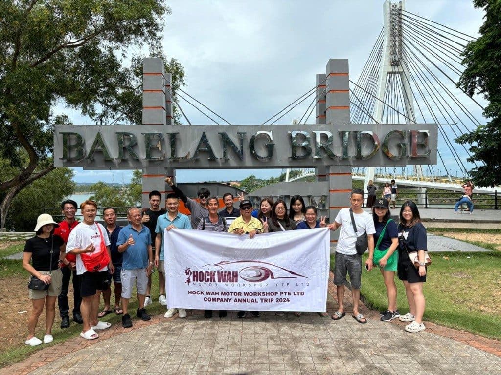 The Hock Wah Motor Workshop team under the Barelang Bridge sign