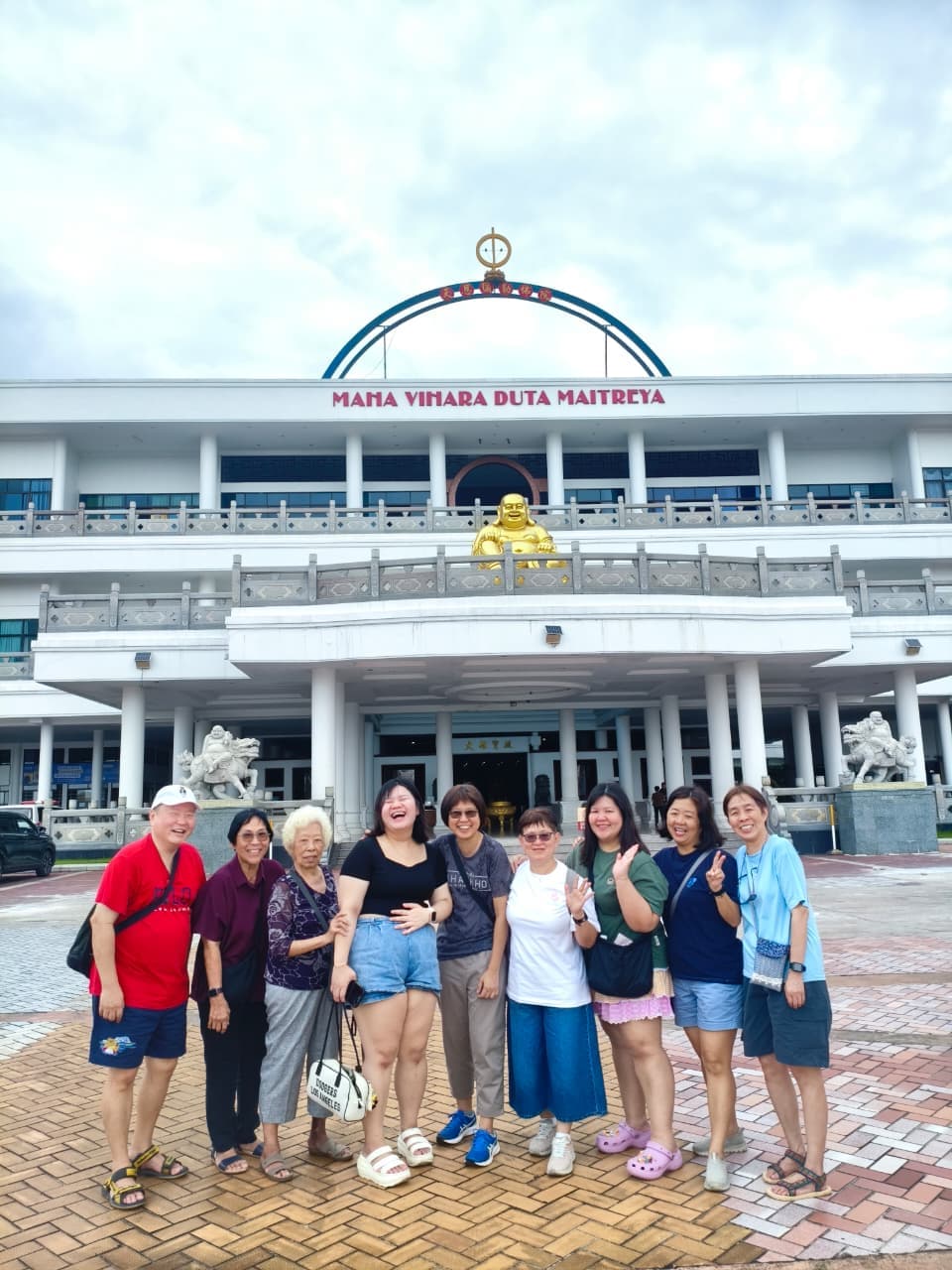 Guests posing in front of the Maha Vihara Duta Maitreya temple in Batam
