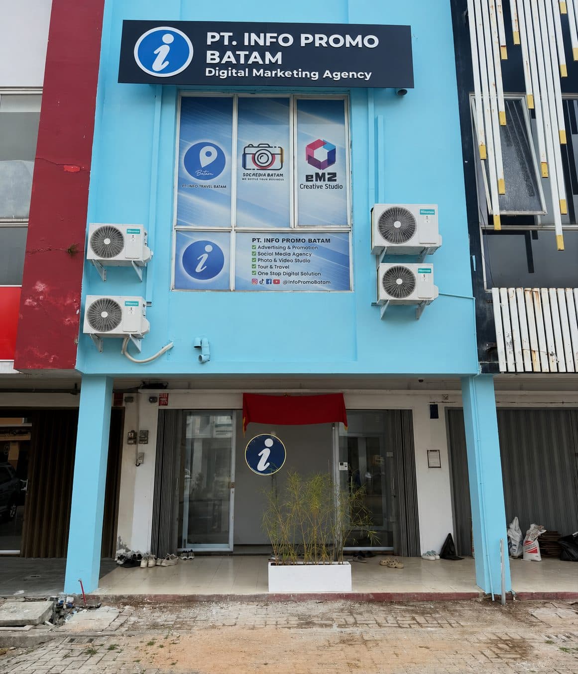 The InfoTravelBatam shopfront in Sukajadi, a light blue unit with the PT. Info Promo Batam sign above it
