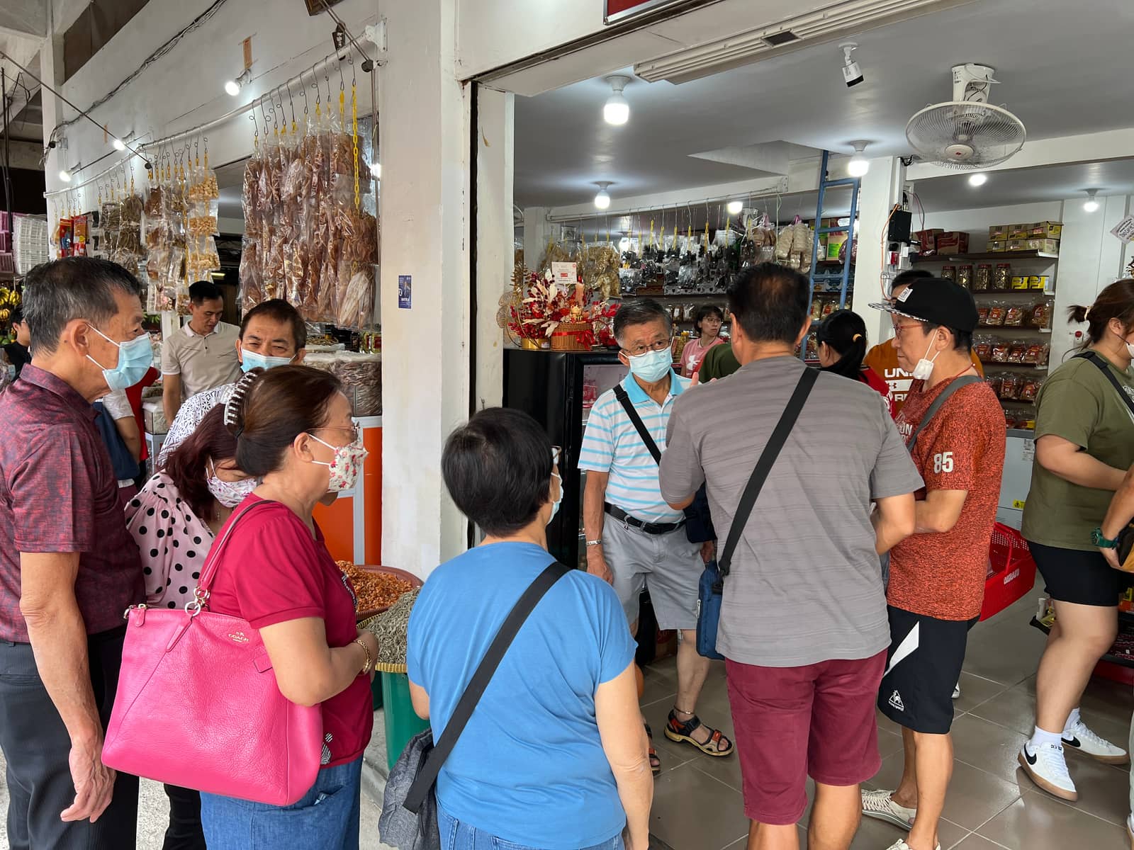 Guests browsing a local dried goods shop stop during a Batam tour